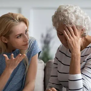 A concerned caregiver overhears an elderly woman speaking, hinting at possible abuse in a nursing home.